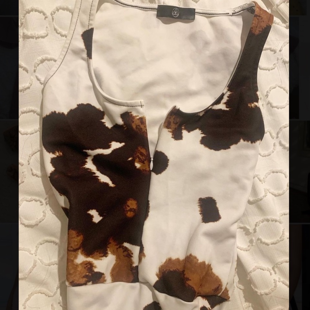 Never worn Misguided zip up cow print bodysuit!